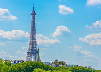 World famous Eiffel tower under a blue sky with clouds