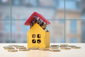 Yellow Piggy Bank House with Coins Savings Concept