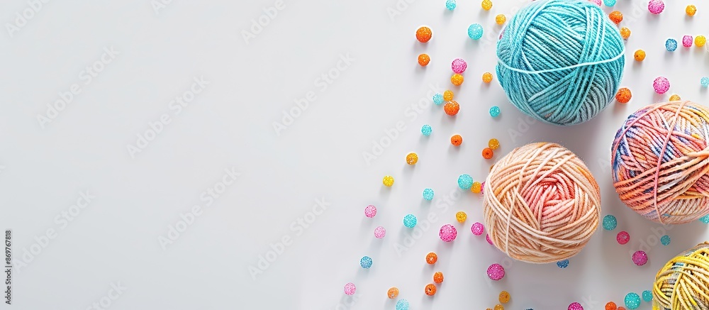 Poster colorful yarn ball and beads on white backdrop, with a space for adding text or images, called copy 