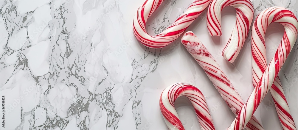 Poster Candy canes displayed with a marble backdrop, providing an elegant frame for the confectionery in a visually appealing copy space image.