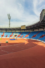 Empty athletics stadium. Part of an athletics stadium with a running track and stands. Sports...