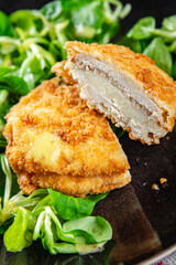 cutlet cordon bleu chicken meat, ham, cheese natural fresh appetizer meal food snack on the table copy space food background rustic top view