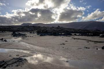 Beach with white sand and lava rocks, Lanzarote