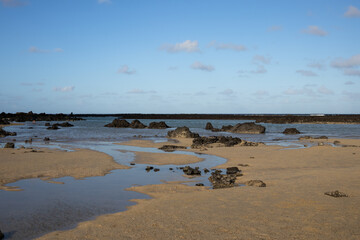 Beach with white sand and lava rocks, Lanzarote