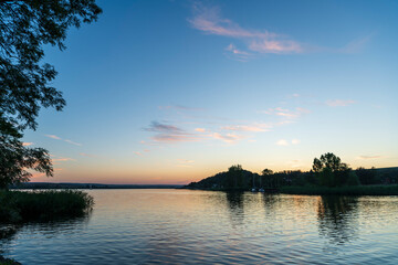 sunset over lake with orange clouds