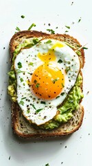 Closeup of a delicious avocado toast with a perfectly cooked sunny-side-up egg