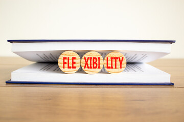 Flexibility symbol. Concept word Flexibility on beautiful wooden circles in book. Beautiful wooden...