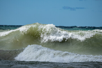Large wave crashing on Lake Michigan in Indiana during hazardous beach conditions 