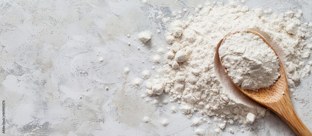 Poster flour and wooden spoon against a plain background with available copy space image.
