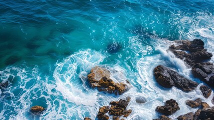 Turquoise ocean waves crashing on rocks. Aerial view of vibrant turquoise ocean waves crashing against rocks, creating a beautiful display of nature's power.