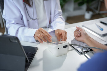 Doctor measuring blood pressure of patient in hospital office