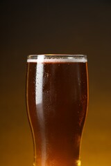 Glass with fresh beer against dark background, closeup