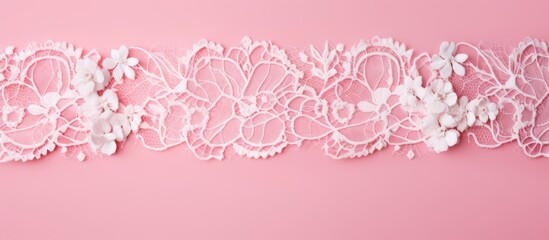Top view of white lace on a pink background with copy space image for text.
