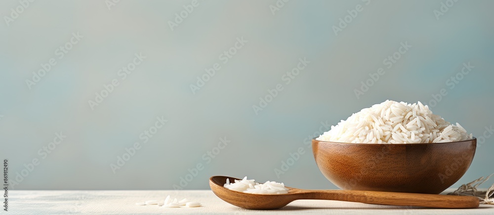 Poster a white bowl holds raw basmati rice with a wooden spoon on a light background, symbolizing water con