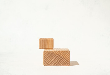 Beauty cosmetics product presentation mockup scene made with textured wooden cube pedestals on white background. Studio photography.