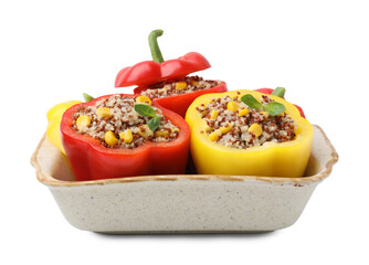Quinoa stuffed bell peppers and basil in baking dish isolated on white