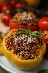 Quinoa stuffed peppers with corn and basil on wooden table, closeup