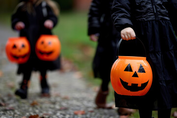 Three children are walking down a path holding orange Halloween pumpkins, generative ai image.