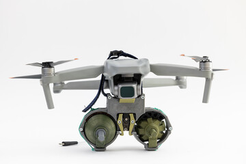 Engineering development for war, army drone with mechanism for dropping grenades on white isolated background. Concept military UAVs using in weapon