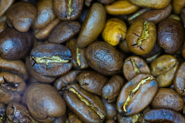 Close-up shot of numerous roasted coffee beans,