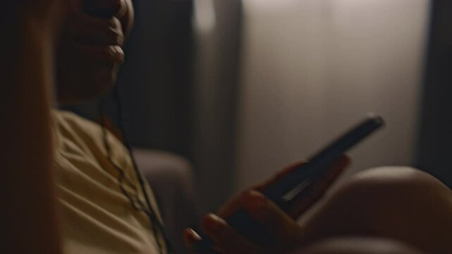 Side closeup of irritated Black woman shouting at her boyfriend during phone call and actively gesticulating with hand indoors. Having anger issues after traumatic events