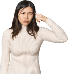 Young Chinese woman pointing temple with finger, thinking, focused on a task.