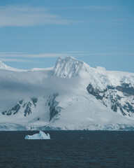 Antarctica Cloud Sweeps in Snow Covered Mountains Beautiful Nature Landscape Ocean Scene in Charlotte Bay. Scenic Sailing from Cruise Ship