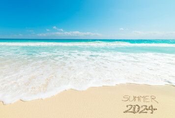 Summer 2024 written on the sand