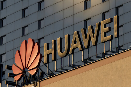 Huawei signage, logo during sunset.