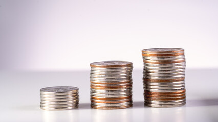 A stack of coins with the top one being the largest and the bottom one being the smallest. The coins are silver and gold.