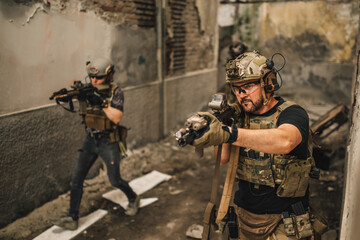 Fototapeta premium Group of brave warriors having mission and going in battle at warzone