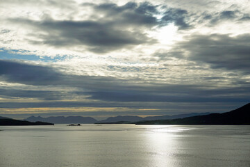 Summer in the fjords of Norway. A bright sunset and cirrus clouds illuminated by the setting sun. HDR light