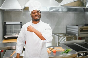 african american chef looking at camera at restaurant kitchen