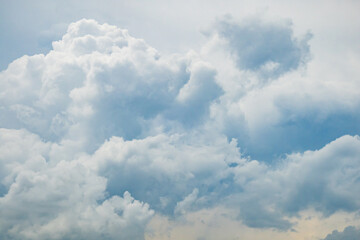 Grey blue sky with white fluffy clouds, natural photography background