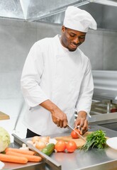 Gourmet chef in uniform cooking in a commercial kitchen.