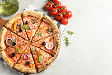 Cut delicious vegetarian pizza, oil and tomatoes on light table, top view. Space for text
