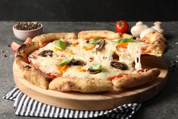 Taking piece of delicious vegetarian pizza at grey table, closeup