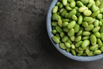 Raw green edamame soybeans on grey table, top view. Space for text