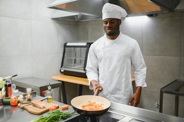 handsome african american chef at restaurant kitchen