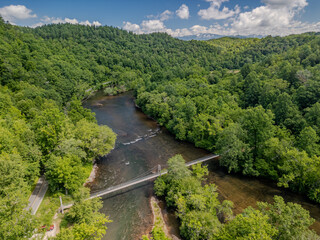 Fototapeta premium mountain walking bridge across river