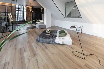minimalist stylish interior of white simple bedroom with window in ceiling and sun rays without...