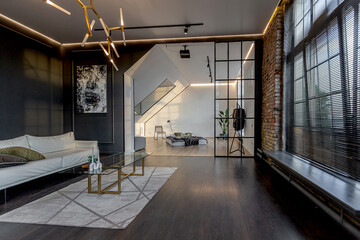 minimalistic stylish interior of luxury apartment with white stylish bedroom and dark living room. modern apartments with an open layout during the day without people and amazing sun rays