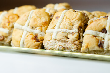 A tray of pastries with a white cross on top