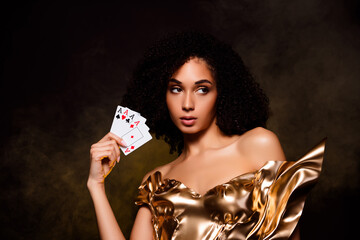 Photo of attractive girl feel tempting look aside hold playing cards isolated dark dust color...