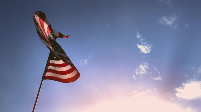 American Flag Slow Motion Blue Sky American Flag in Slow Motion. Celebrate USA and 4th of July with video if flag waving wind. Great for History, corporate projects.