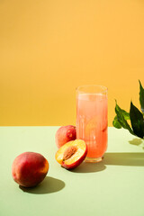 Cocktail or mocktail in glass and fruit peach half and whole