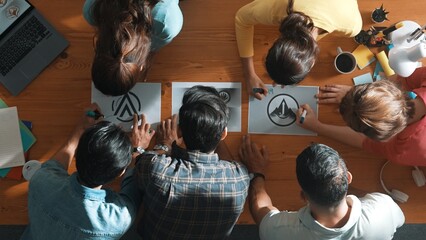 Top view of business team put graphic logo on meeting table with laptop and paper and start to...