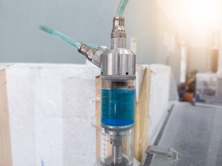 Close up the piston cylinder tube contains medicinal liquid for spray vaccine for hatching chicks.