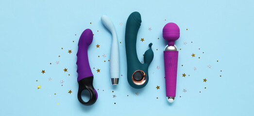 Different sex toys on light blue background, top view
