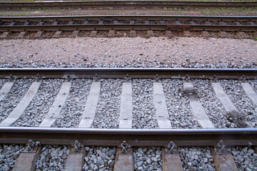 Railway sleepers and rails on a stone background, close-up. Rail, railway line.